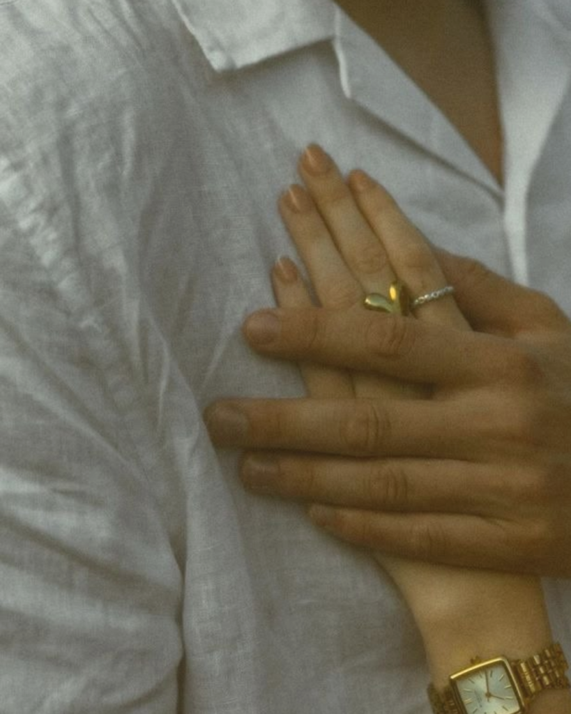 Hand resting gently on the chest