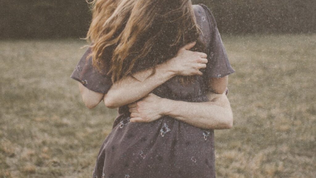 Couple embracing in a field