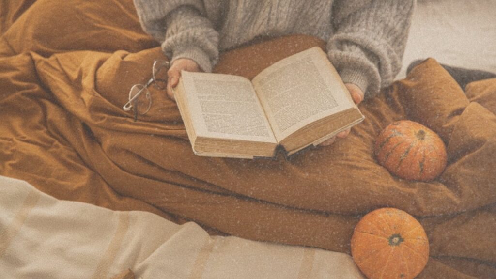 Reading with pumpkins on the bed