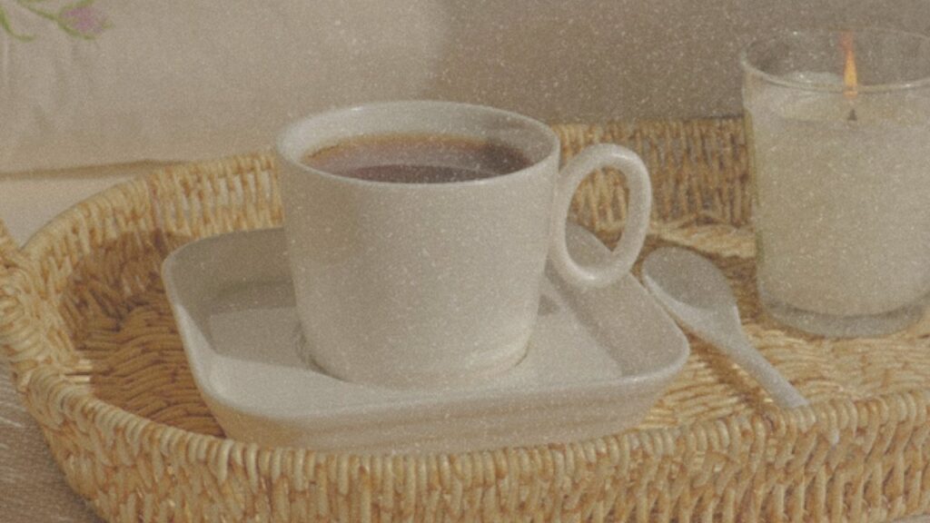 Tea and candle on a wicker tray