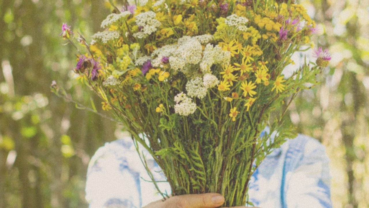 Holding a big wildflower bouquet