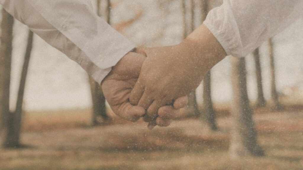 Holding hands in an autumn forest
