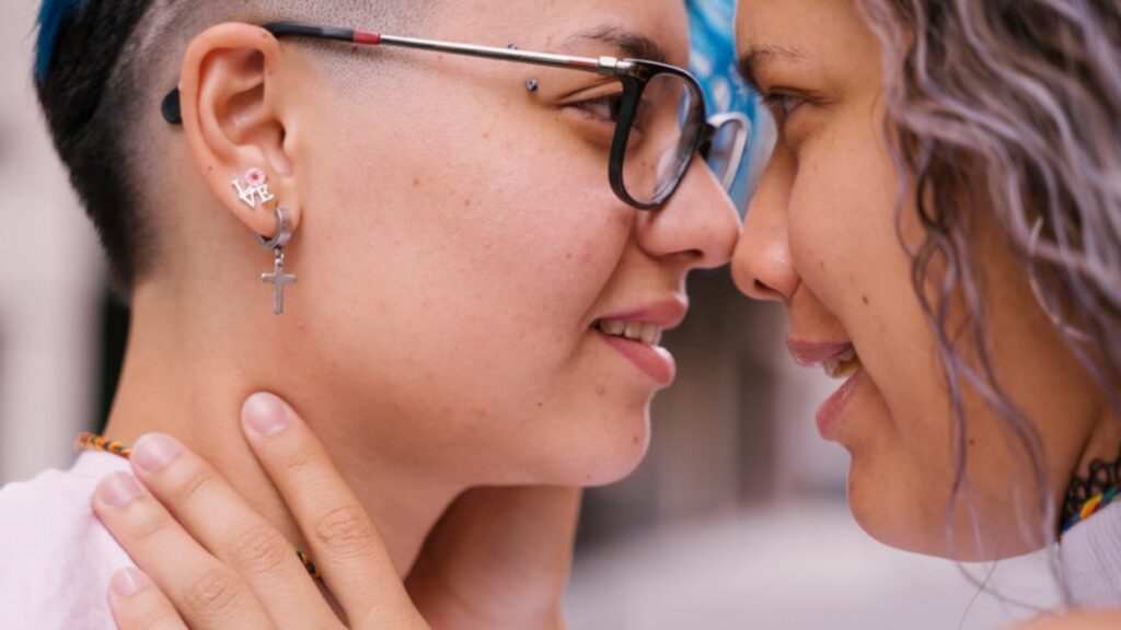 Two women touching foreheads and smiling